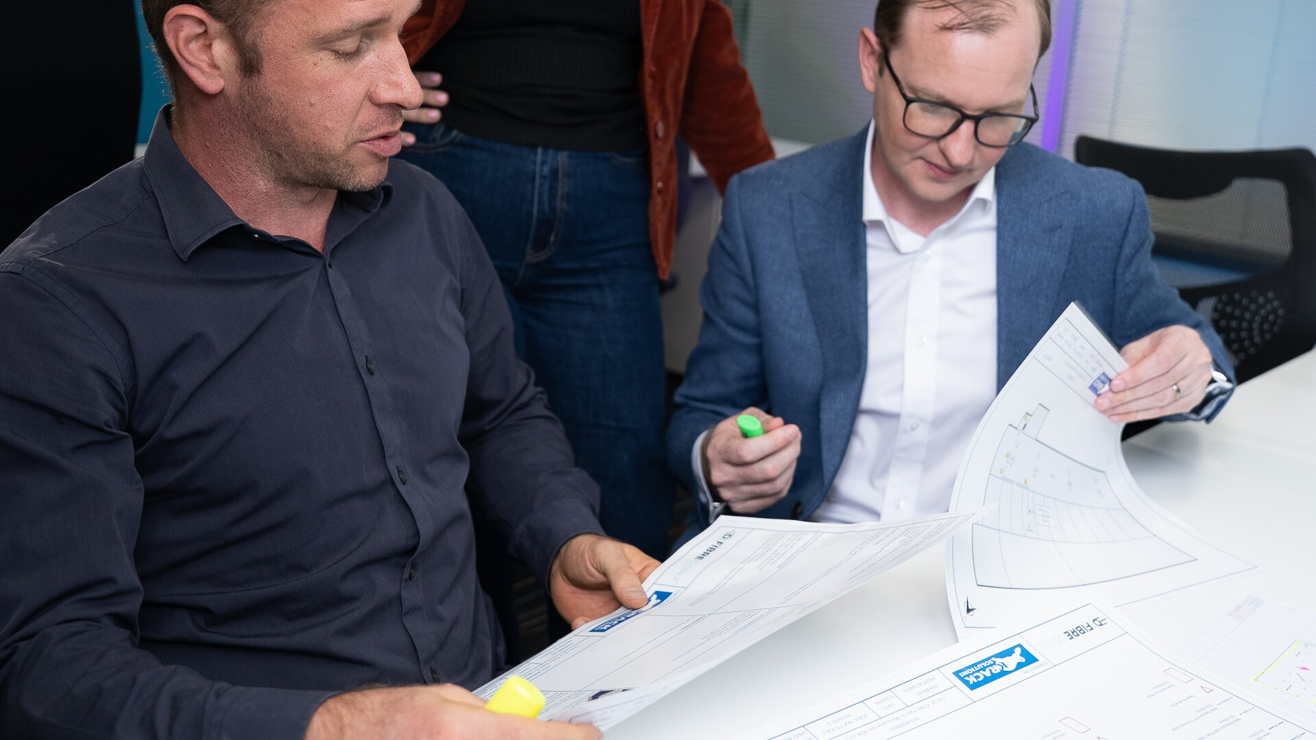 Real World team in a workshop with documents and materials